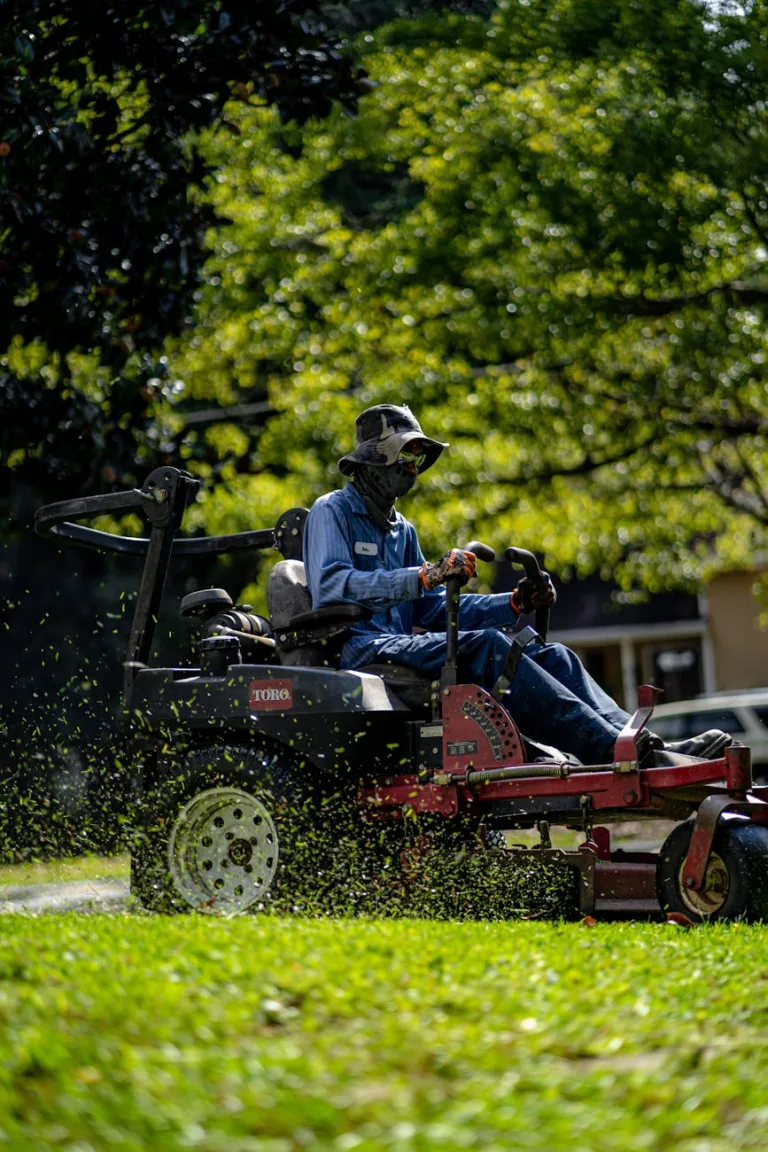 a person mowing the lawn grass